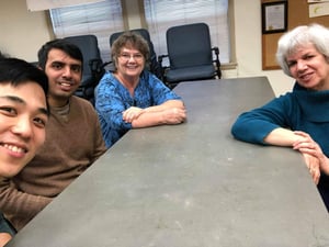 Lifelong members watch movies at a table