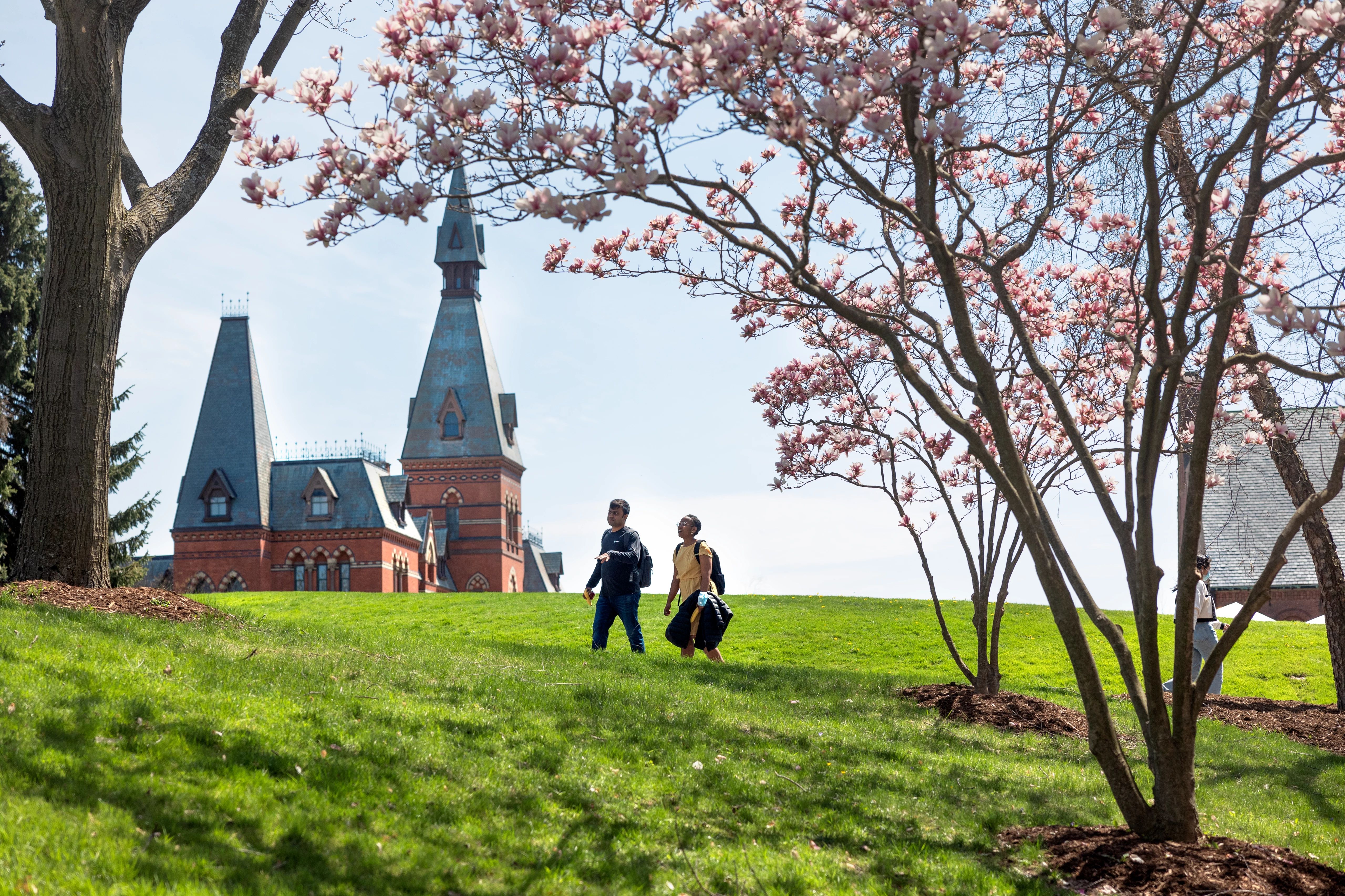 Two students walking along Cornell's campus.